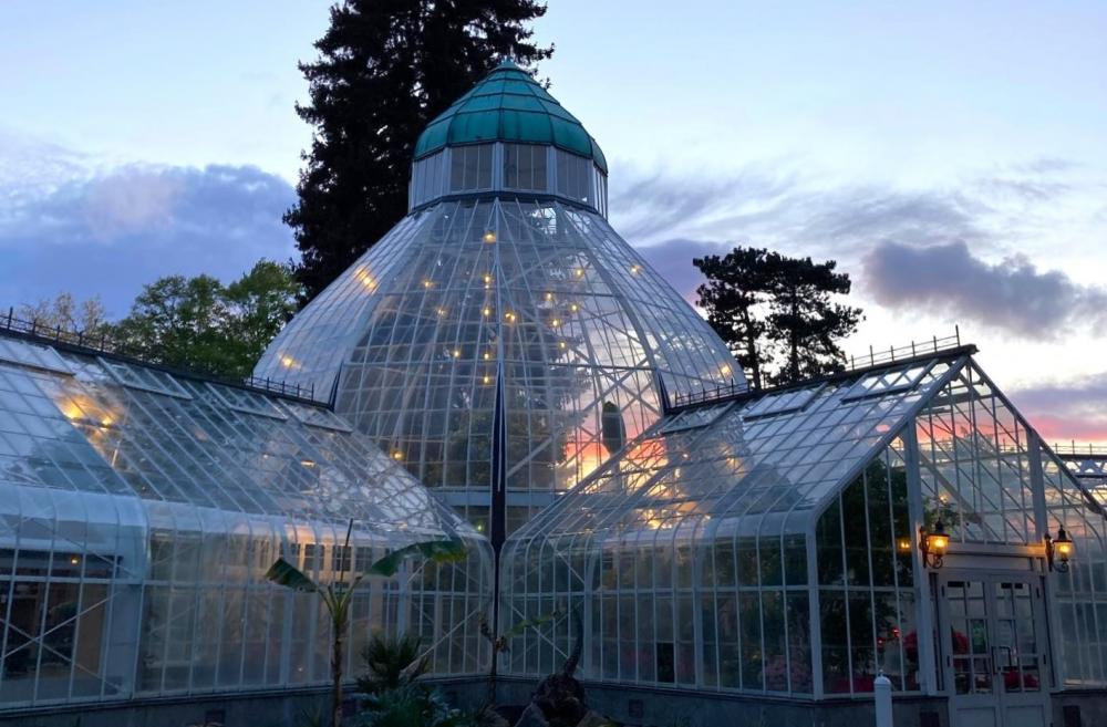 Exterior of the W.W. Seymour Botanical Conservatory in Tacoma's Wright Park seen at night with lights inside