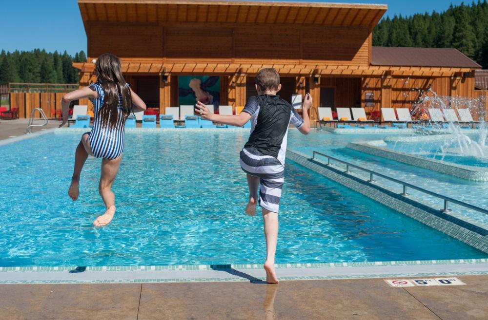 Kids jumping into the Nelson Dairy Farm swimming pool at Suncadia Resort among nearby summer getaway spots for Seattle families