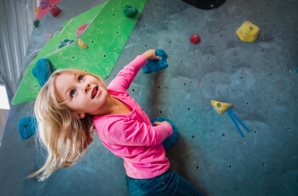 Young girl on a rock climbing wall