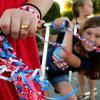 Child and bike decorated for a Fourth of July neighborhood parade or party Independence Day crafts and fun for kids