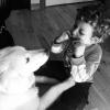 A young boy plays a harmonica for his dog a benefit of having a pet