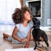 young girl on the floor with her small dog and art supplies