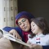 grandmother and granddaughter reading together