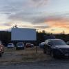 view of cars parked at a drive-in movie theater near Seattle at sunset
