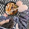 Young girl in flowered jacket eats ox tail noodle soup from Spice Bridge Food Hall in Tukwila Washington near Seattle