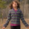 Child practicing mindfulness breathing exercises out in nature