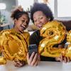 Mom and daughter taking selfie with balloons happily celebrating new year 2022 best family events around Seattle Tacoma Bellevue Puget Sound