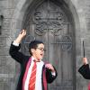 Two boys in Hogwarts robes and holding wands pose at Universal Studios Hollywood's Wizarding World of Harry Potter top tips for visiting with kids