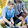 Coach-helping-injured-soccer-player