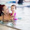 Woman holding a baby in a pool at a Seattle swimming lesson