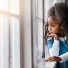 Young girl looking out a window