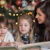 Mom-reading-to-kids-by-Christmas-tree