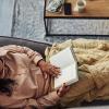Woman-reading-a-book-on-sofa