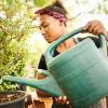 girl watering plants is one of those easy summer jobs for teens that doesn't take much experience