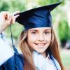 Young girl wearing a college graduation cap and gown