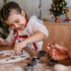 Young girl smiling making Christmas cookies