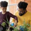 dad and son planting houseplants and connecting with nature