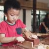 Young boy doing a woodworking project at a seattle art summer camp