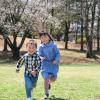 boy and girl running through cherry blossom trees during spring break
