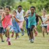 Group of kids running in a field benefits of running