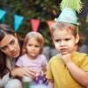 young child looks sad at a birthday party