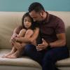 Dad and daughter talking on a couch