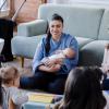 New moms sitting in a living room together connecting as new parents 