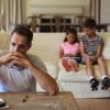 dad sitting with kids looking thoughtful, he has lost his job