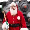Santa stands in front of a Christmas train on the Mt. Rainier Scenic Railroad, a holiday train ride with tickets on sale now