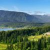 aerial view of the exterior of Skamania Lodge, nestled in the forest with mountains behind it
