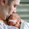 dad with infant in the hospital at a NICU