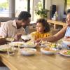 family sitting around a table eating together