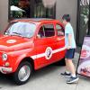 young boy walking up to vintage Fiat outside Piatti, a fun Seattle brunch spot