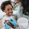 Girl smiling after getting a vaccine shot