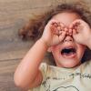 a young girl crying on the floor with hands over eyes after getting home from school and having a tantrum