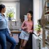 mom and teen daughter talking in the kitchen