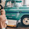 preteen in front of a truck at LeMay – America's Car Museum in Tacoma, a fun place to take kids