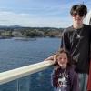 three kids standing on the deck of a cruise ship heading to Alaska