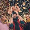 Family in front of holiday lights