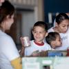 boy and his family at a food bank volunteering