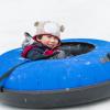 boy in a snow tube having fun