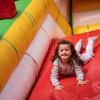 young girl sliding down inflatable slide during a seattle kids night out