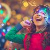 little girl laughing and playing with holiday lights