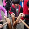 kids pounding mochi with wood mallets during Mochi Tsuki, a family-friendly festival happening this weekend near Seattle