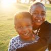 Black History Month events with smiling African American boy and girl hugging each other. 