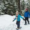 family snowshoeing together