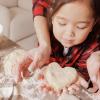 mom and daughter making Valentine's Day treats together in the kitchen