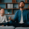 young father teaching little daughter meditation