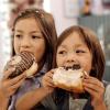 kids eating doughnuts on a walking food tour in Seattle
