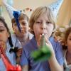 children holding party blowers and having fun